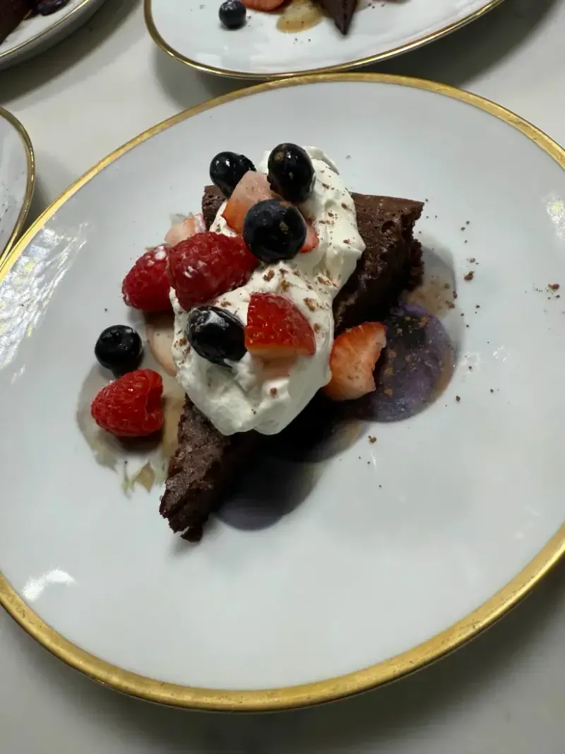 Flourless chocolate cake with whipped cream and fresh berries dessert