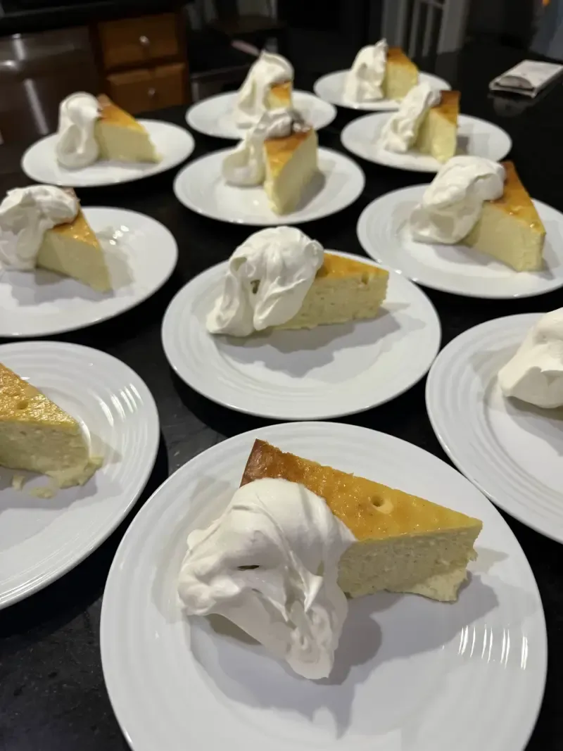Olive oil cake slices with whipped cream plated for private dinner party
