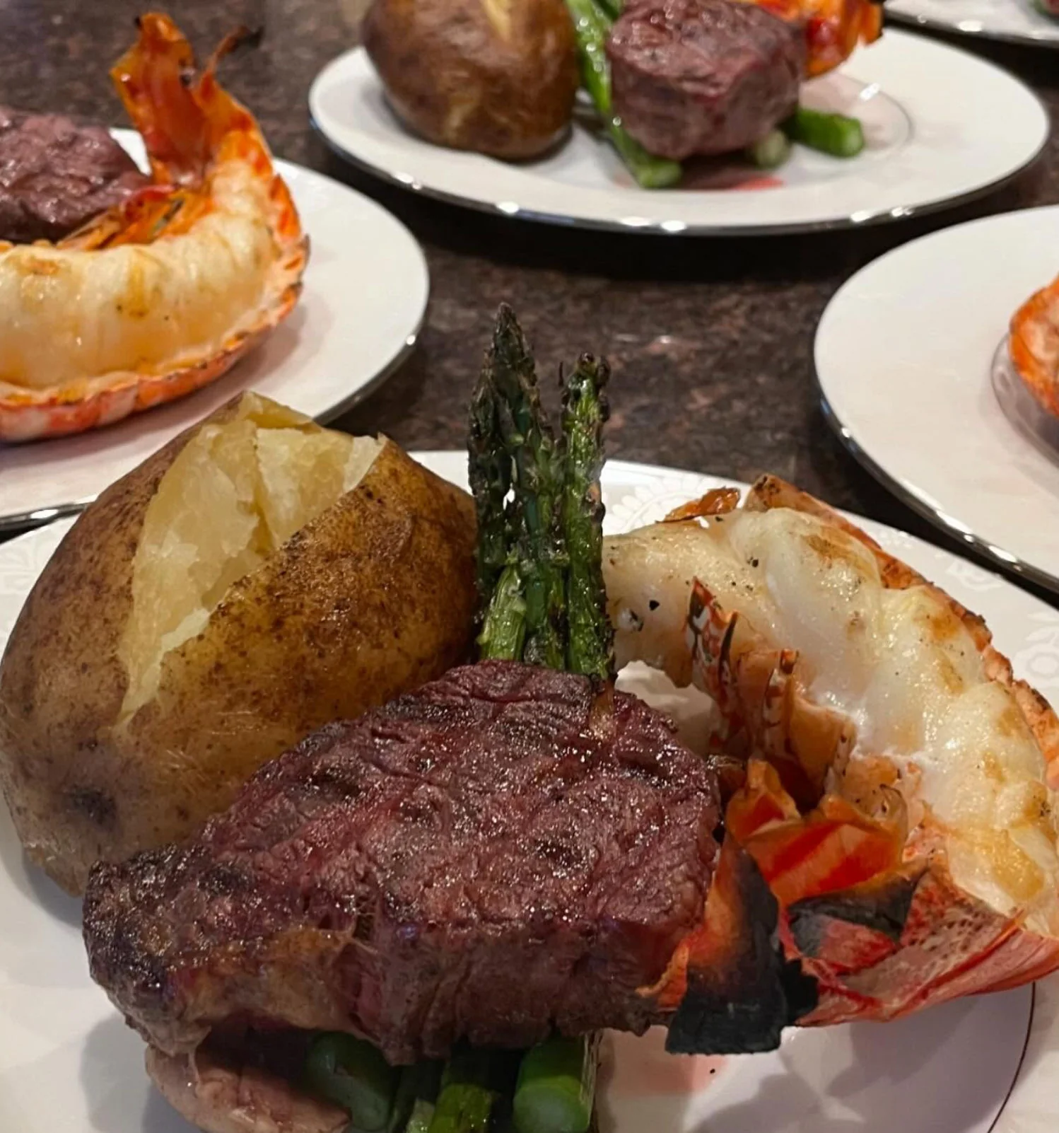 Filet mignon with lobster tail, asparagus, and baked potato